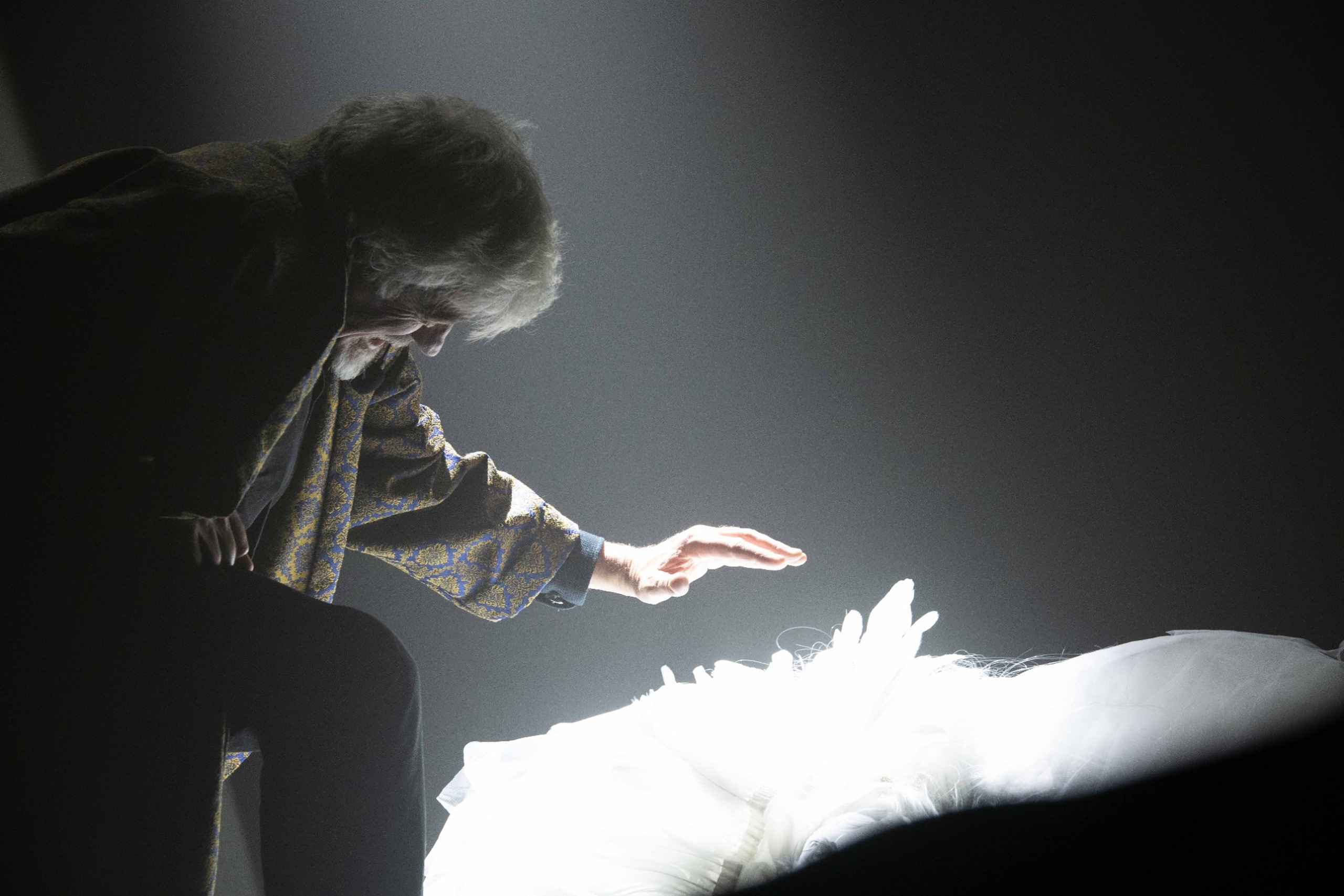 Scrooge reaches towards a vision in white